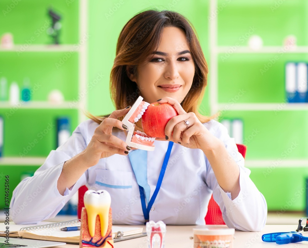 Woman dentist working on teeth implant Woman dentist working on teeth implant