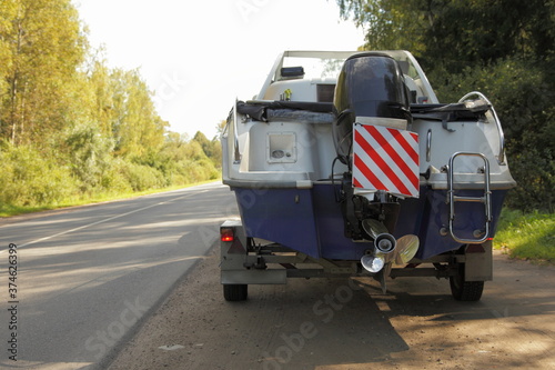 Fotografi Motor boat on Car trailer with transom stern with powerful 100hp outboard motor