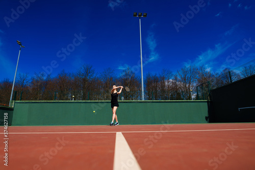 Sensual woman with tennis racket at net on lawn. Activity, energy, power. Sport, training, workout. Wellness, health. © Ivan Zelenin