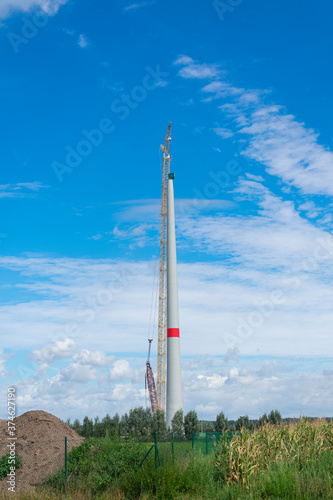 Construction of a wind turbine with a blue sky and white clouds as a background