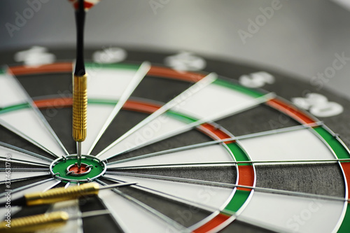 Darts. The dart for playing in the game board is stuck. Hit the sector in darts. The concept of a successful strategy.