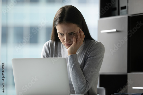 Φωτογραφία Unhappy dissatisfied businesswoman looking at computer screen, stressed young wo