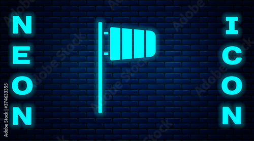Glowing neon Cone meteorology windsock wind vane icon isolated on brick wall background. Windsock indicate the direction and strength of the wind. Vector.