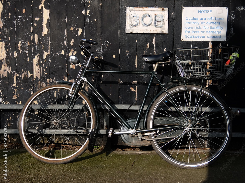 Vintage bicycle parked in front of a wall