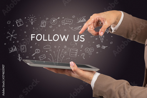 Close-up of a touchscreen with FOLLOW US inscription, social media concept