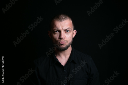 Emotional man portrait on black background