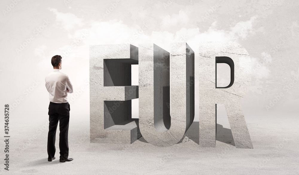 Fototapeta premium Rear view of a businessman standing in front of EUR abbreviation, attention making concept