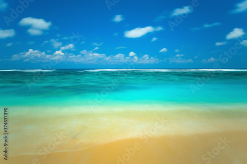 Indian ocean and beach landscape. Image features blurred water movement captured with a long exposure.