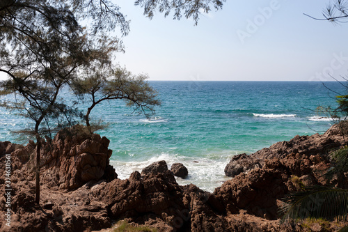 Landscape nature scenery view of Beautiful tropical sea with Sea coast view in summer season and wave crashing on rocks in the foreground.