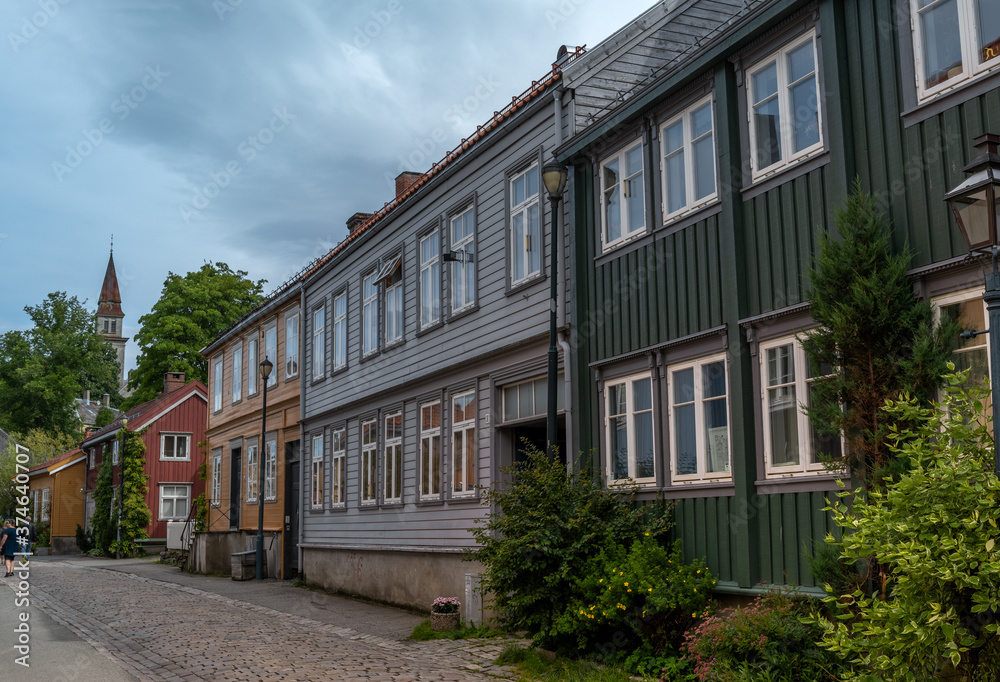 Fototapeta premium The colorful back streets of the old city wharves district along the Nidelva river in Trondheim, Trondelag, Norway. Symbol of the historical role of Trondheim as a merchant city.