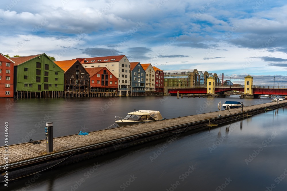 Obraz premium The colorful and iconic old city wharves along the Nidelva river in Trondheim, Trondelag, Norway. Symbol of the historical role of Trondheim as a merchant city.