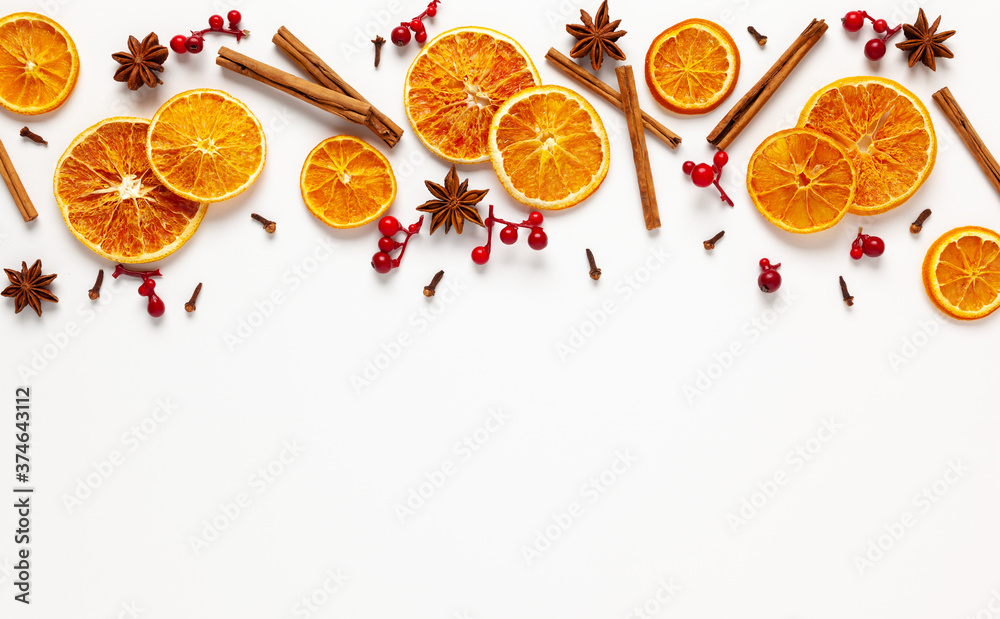 Naklejka Christmas composition with dried oranges and spices on white background. Natural food ingredient for cooking or Christmas decor for home. Flat lay.