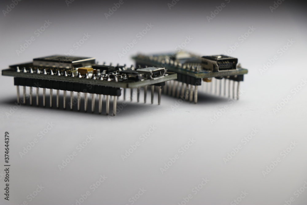 Nodemcu wifi development board and arduino nano board on white background. Open source board for Internet of things project. iot concept. Circuit board pinout closeup Nodemcu wifi development board and arduino nano board on white background. Open source board for Internet of things project. iot concept. Circuit board pinout closeup