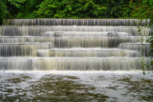 White Water flowing over weir low-level view at long exposure for blurred water effects and textures 