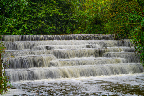 White Water flowing over weir low-level view at long exposure for blurred water effects and textures 