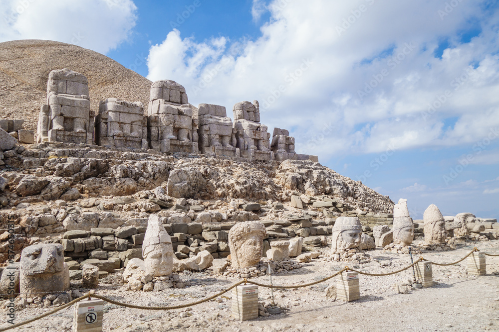 Panoramic view onto complex of ancient statues of Gods, mount Nemrut, Kahta, Turkey. Heads fell during earthquake. Complex built in 1 century BC. Place included in UNESCO List