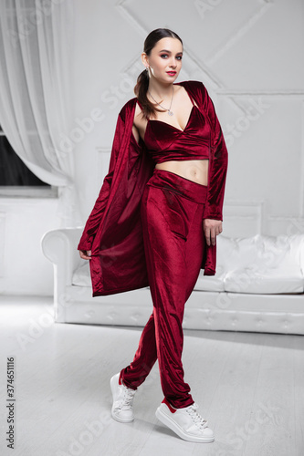 Fotografie Nice brunette dressed in a burgundy velor suit