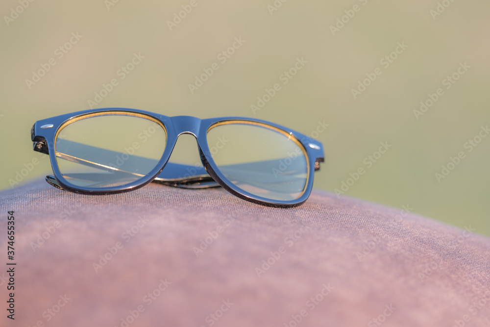 Classic sunglasses model with yellow lenses closeup. Selective focus