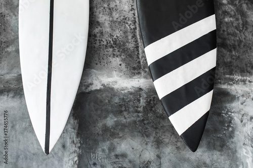 Photography Black and white color surf board on gray concrete wall background