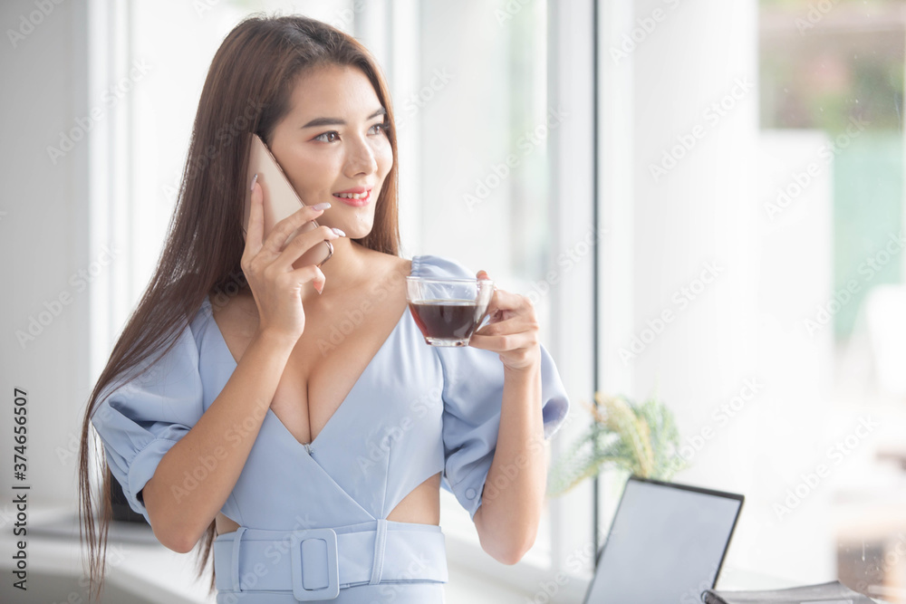 Protrait of Beautiful businesswoman sitting at desk and working with laptop smartphone and computer. Protrait of Beautiful businesswoman sitting at desk and working with laptop smartphone and computer.