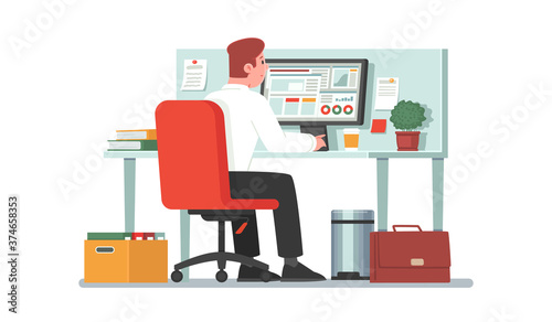 Office employee sits at a desktop in front of a computer monitor. Clerk or accountant, financial analyst works