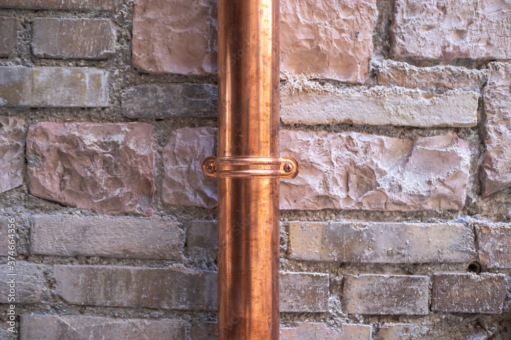 old brick wall with a new copper downspout old brick wall with a new copper downspout