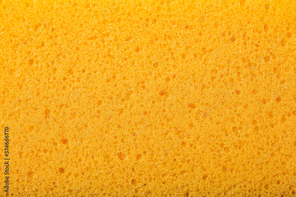 Fototapeta premium Yellow sponge background, close-up sponge.