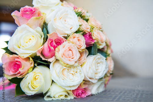 Wedding. The bride's bouquet of roses lies on the table close up. Wedding bouquet