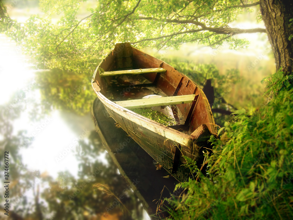 Landscape with wooden rowboat in early sunrise lights