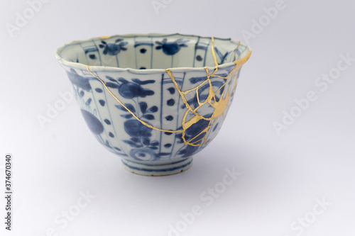 Kintsugi blue and white tea ceremony chawan tea bowl. Gold cracks restoration on old Japanese pottery restored with the antique Kintsugi restoration technique. The beauty of imperfections. 