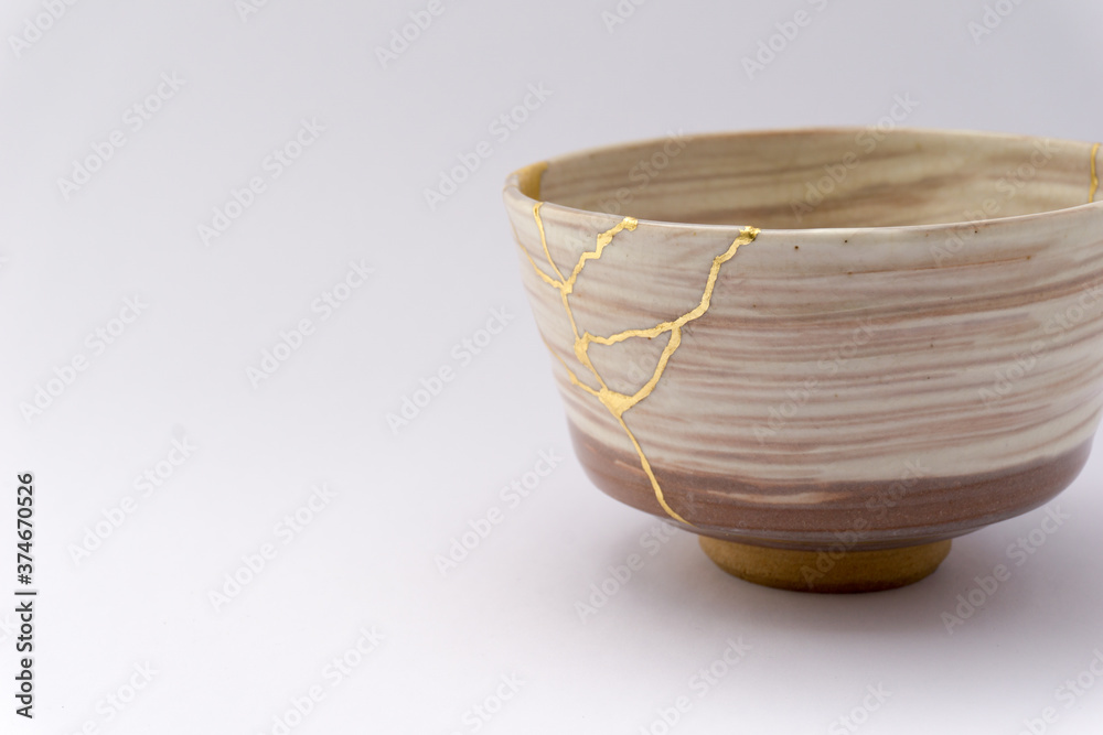 Kintsugi beige tea ceremony chawan bowl. Gold cracks restoration on old