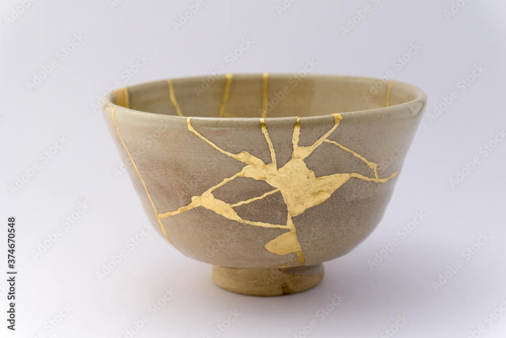 Kintsugi beige tea ceremony chawan bowl. Gold cracks restoration on old