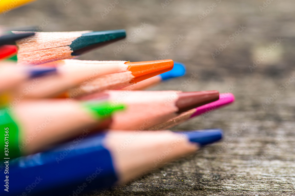Color pencils on weathered aged pine wood boards close up macro shot, space for text. Color pencils on weathered aged pine wood boards close up macro shot, space for text.