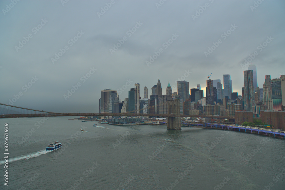 Fototapeta premium Cloudy Manhattan skyline from Manhattan Bridge, NYC, NY, USA