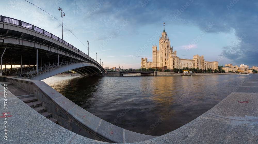 Fototapeta premium Sunset view of Kotelnicheskaya Embankment Building and Moscow river in Moscow, Russia.