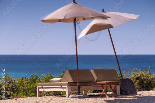 Beach chairs and umbrella by the sea