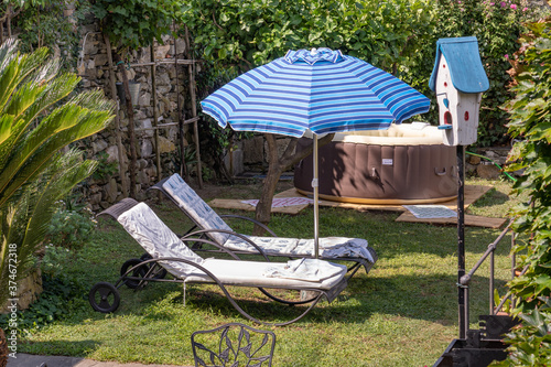 Sun loungers in a garden with umbrella