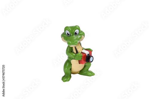 Crocodile toy figure with camera on white background under clipping © Serhii