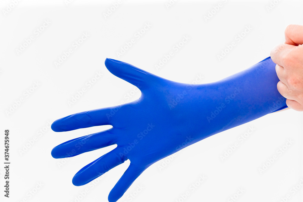 Hand in a blue diagnostic glove Hand in a blue diagnostic glove