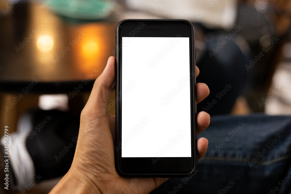 man hand using smartphone In the coffee shop,Screen blank with clipping path