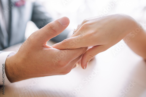 gentle touch of the hands of a man and a woman. husband gently strokes his wife on the hand,