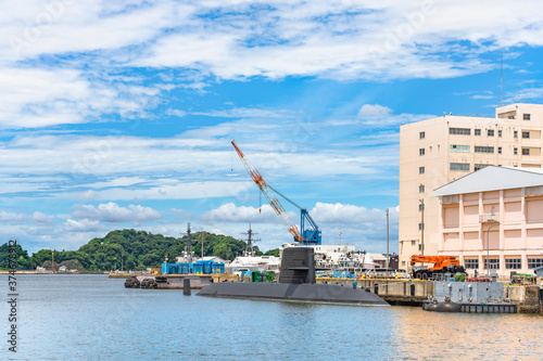 yokosuka, japan - july 19 2020: Wide angle view of the japanese submarine Takashio berthed in front of the japan maritime self-defense force Second Diving Group Command in the Yokosuka naval port. photo