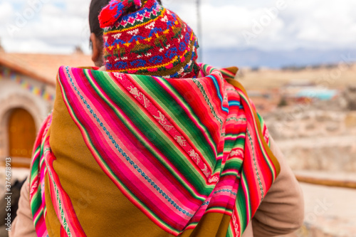 Woman with traditional colourful clothing with her baby , in Chinchero, Peru photo