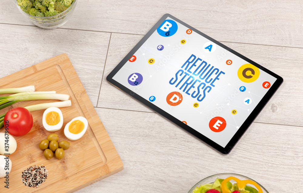 Healthy Tablet Pc compostion with REDUCE STRESS inscription, weight loss concept Healthy Tablet Pc compostion with REDUCE STRESS inscription, weight loss concept