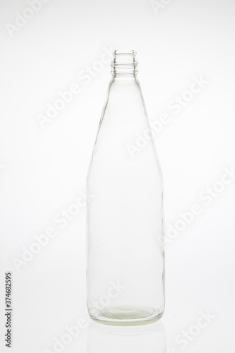 Isolated glass bottle on white background without cap.