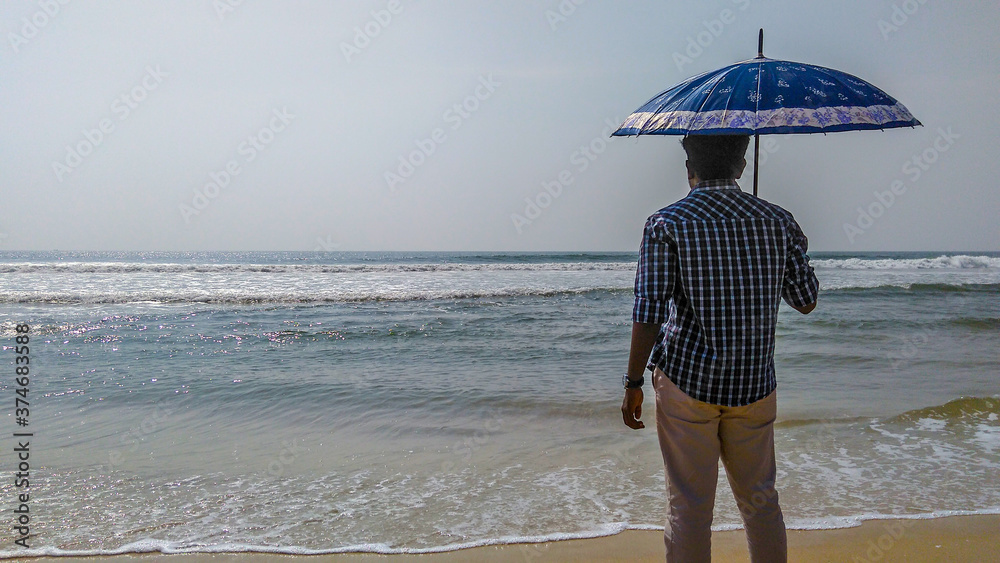 young man standing on the beach young man standing on the beach