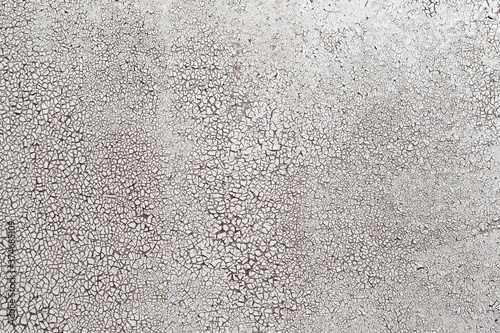 Cracked surface texture. Many small cracks on white paint. Old metal wall. Perfect for background and design.