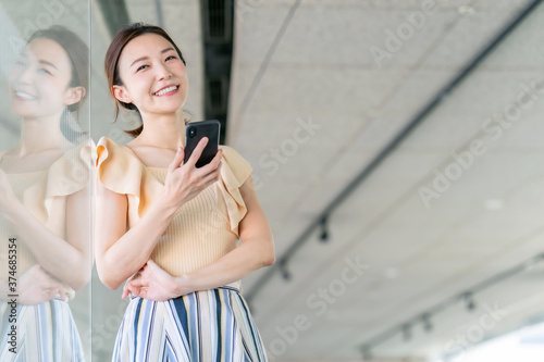 Woman at office using smartphone.