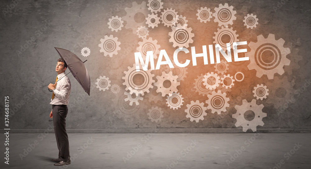 Businessman defending with umbrella from MACHINE inscription, technology concept Businessman defending with umbrella from MACHINE inscription, technology concept