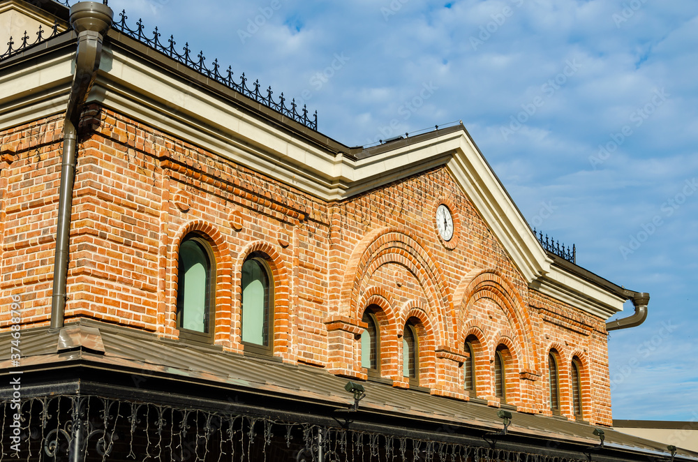 Fototapeta premium Old brick building with a clock .